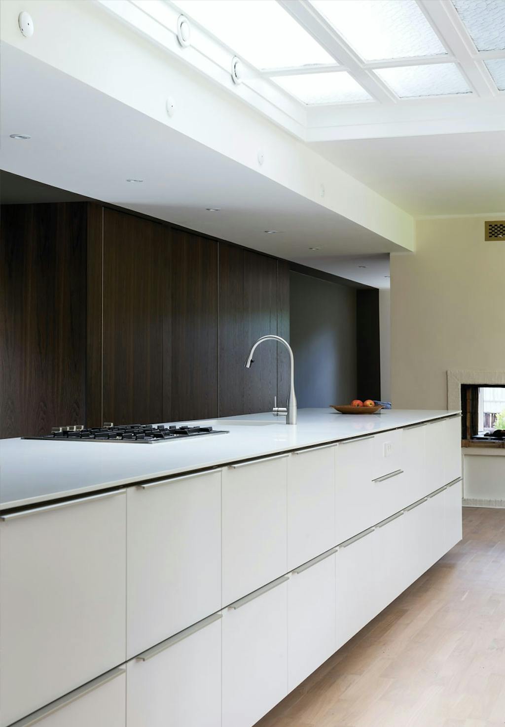 Lyst køkken med panelvæg i røget eg