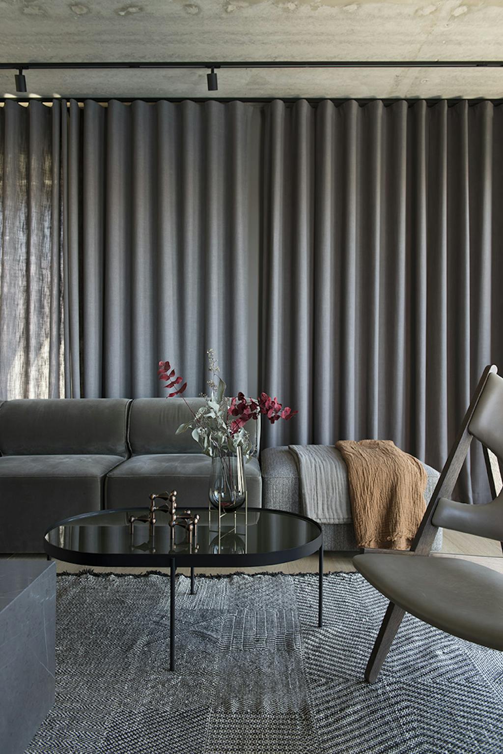 Stue med grå sofa og lange gardiner