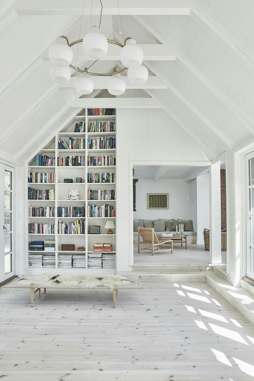 Stue i sommerhus med indbygget reol og lysekrone