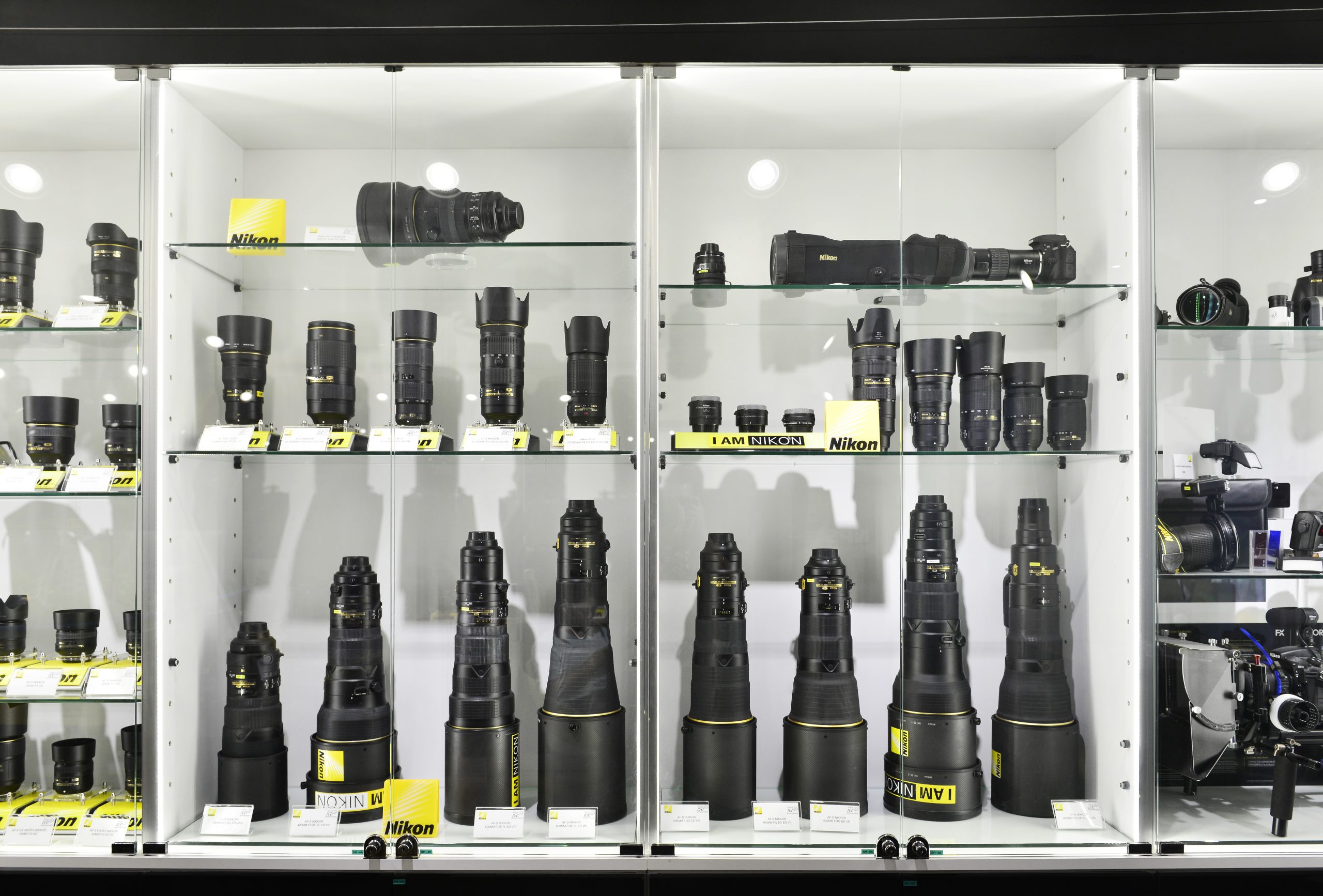 kaappi täynnä peilijärjestelmäkameroita ja objektiiveja aloittelijoille ja ammattilaisille