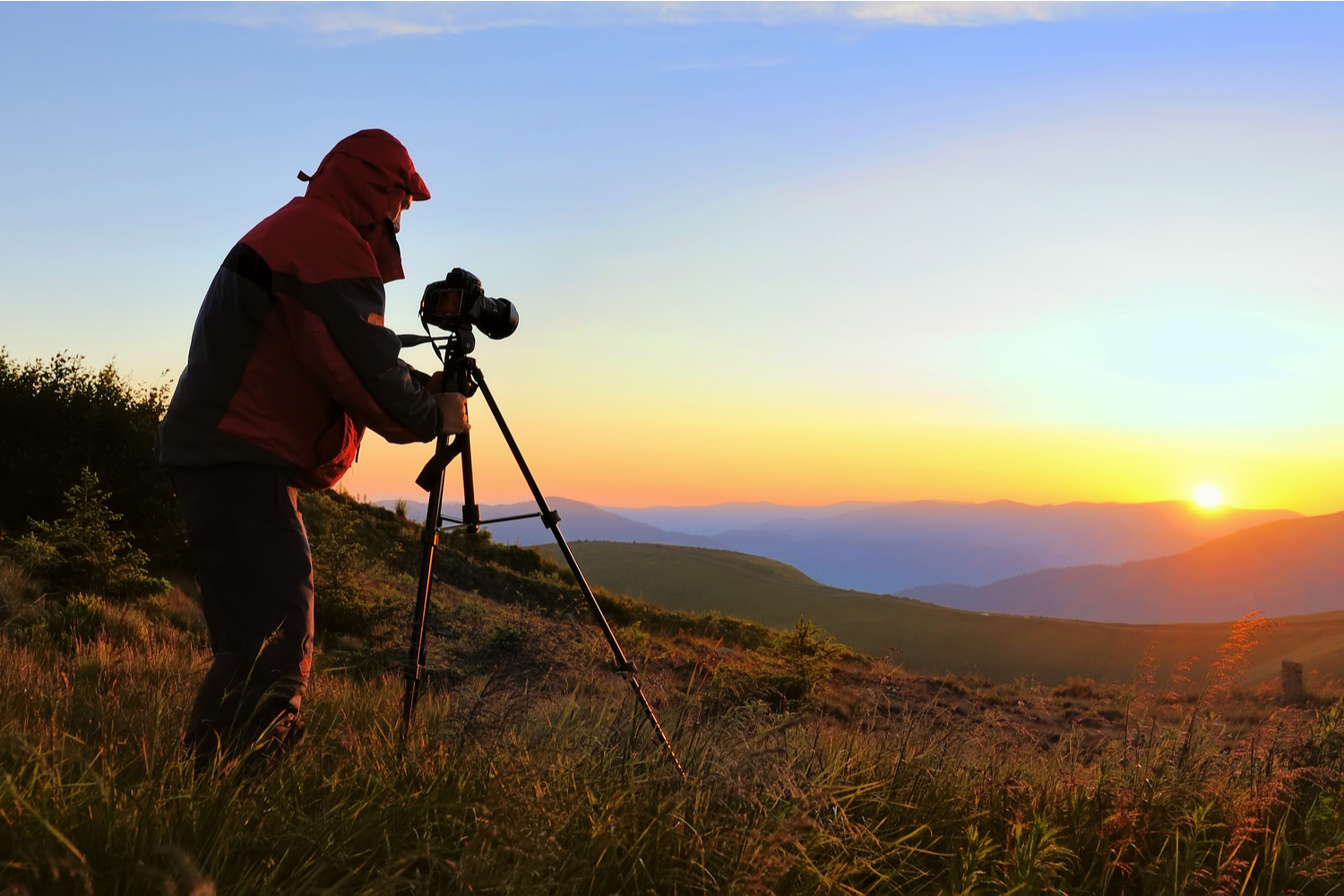 Mann fotograferer solnedgangen.