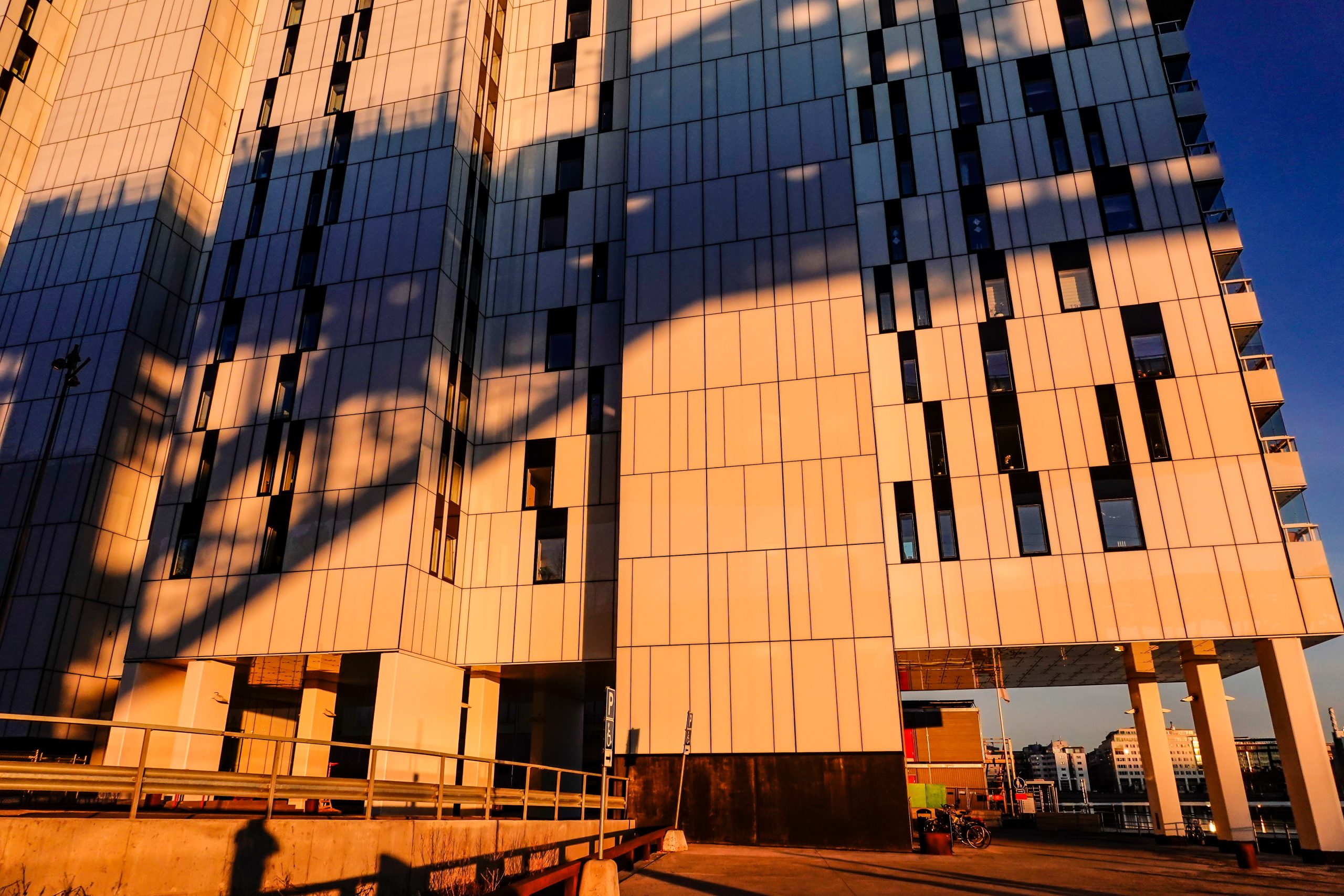 Höghus i Stockholm med skuggor från kran.