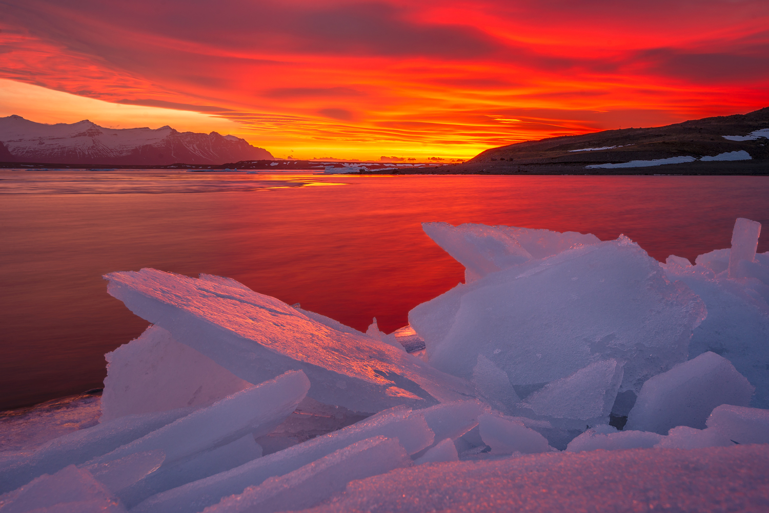 Punainen auringonlasku Jökulsárlón-jäätikköjärvellä Islannissa