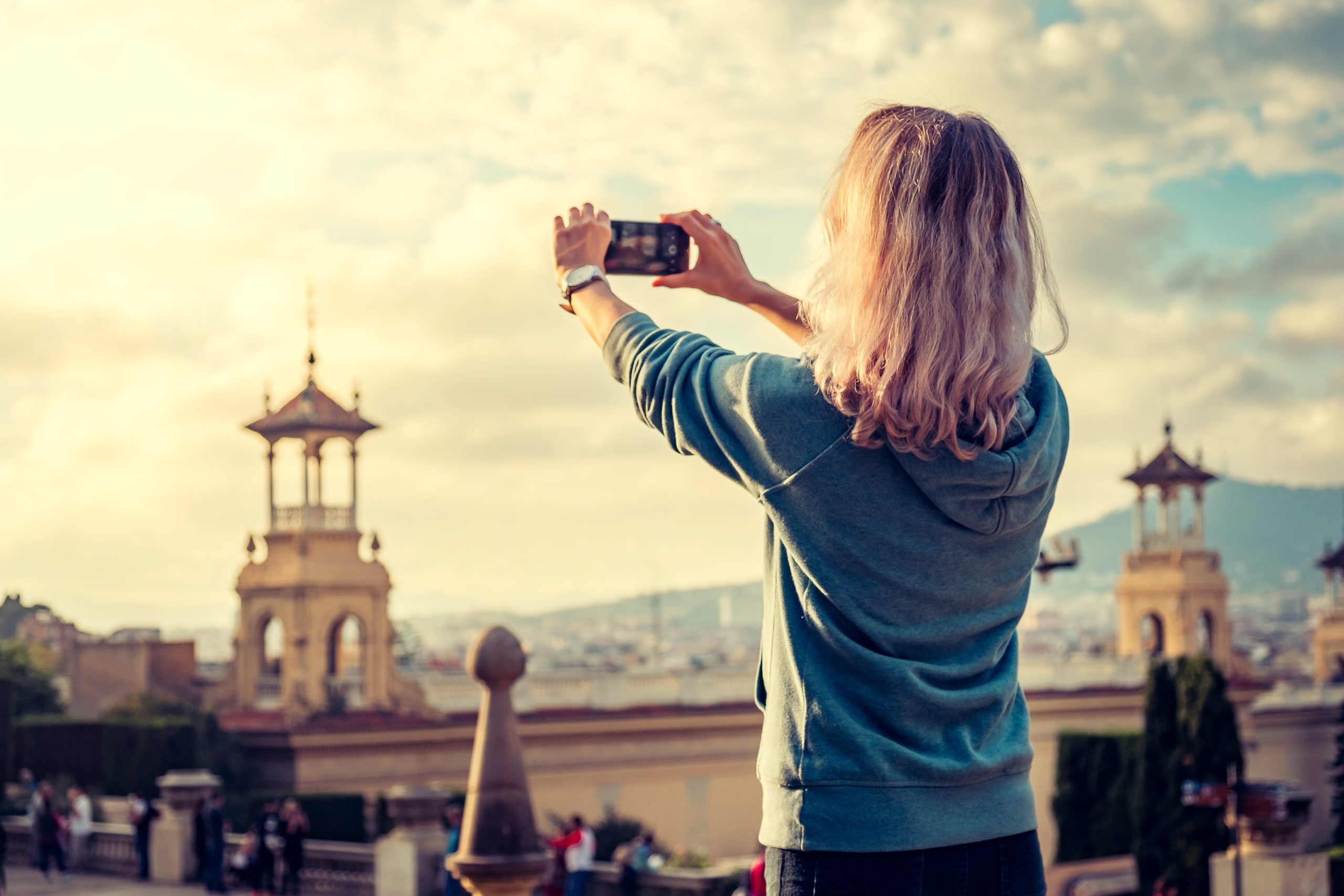 Kvinde fotograferer byen med sin smartphone