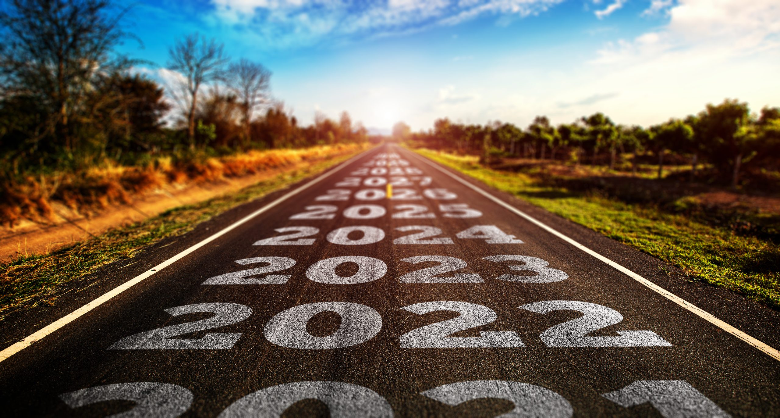 vei med skrift i form av årstall som beveger seg frem mot horisonten symboliserer utviklingen av kamerateknologier, før og inn i fremtiden