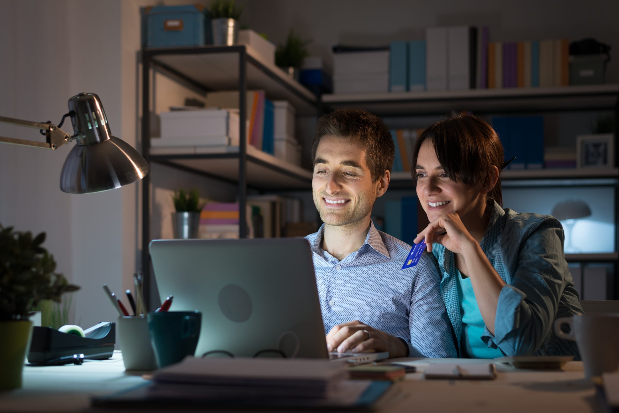 Mann og kvinne sitter foran en datamaskin.