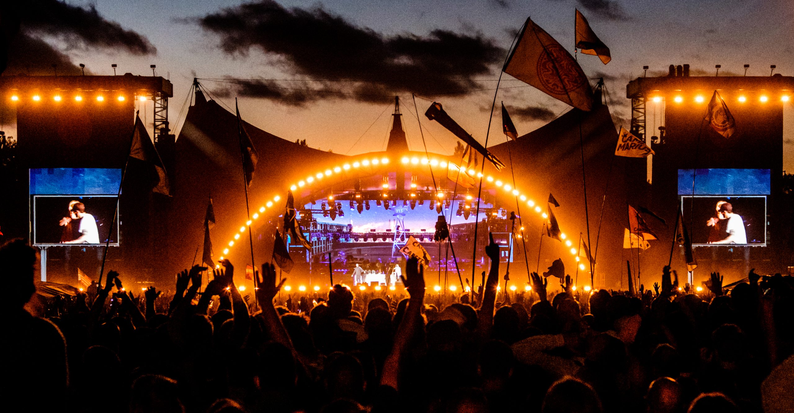 publikum strekker opp hendene på konsert