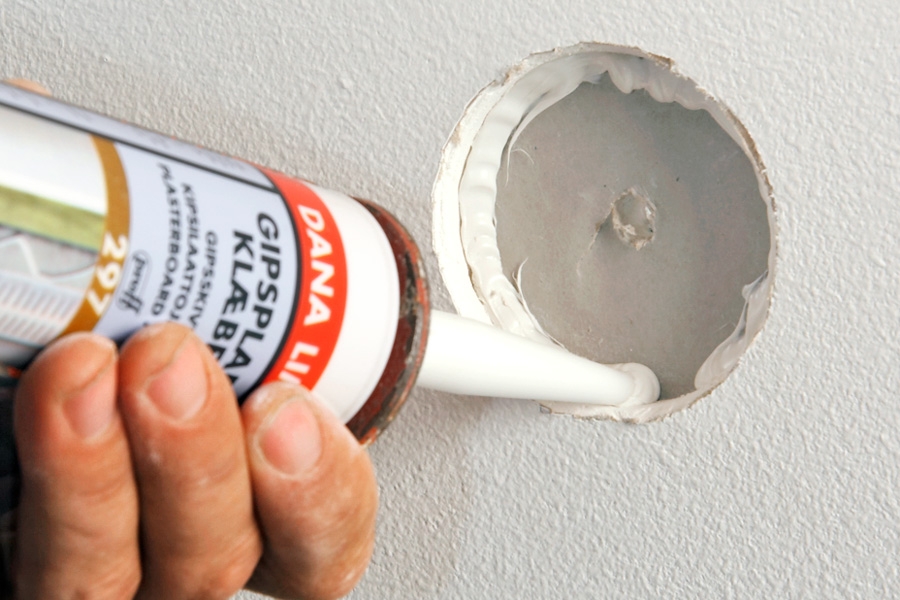 Tett hullet i vegger med to lag gips (små hull): Legg gipsplatelim i hullet, og trykk proppen forsiktig inn. La det tørke et døgns tid.