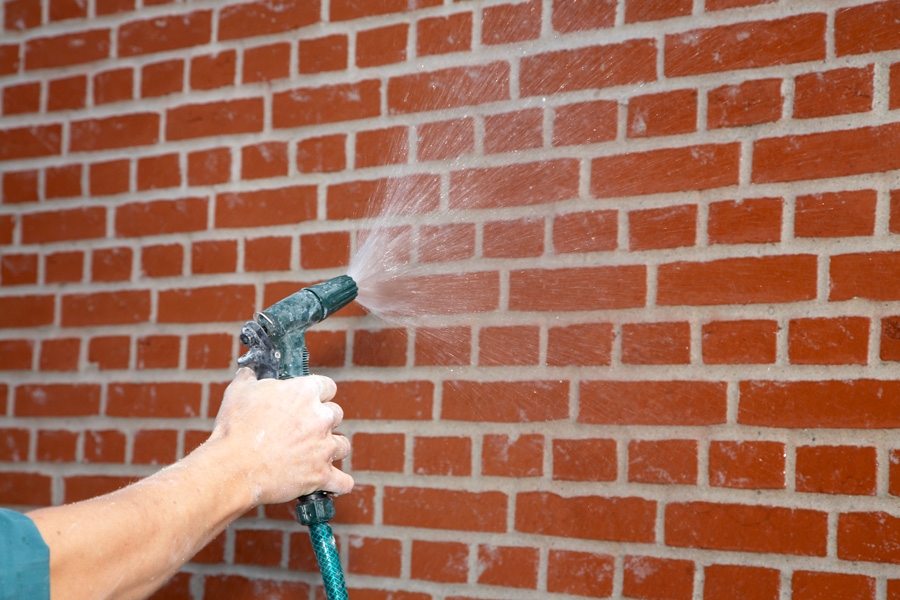 Mal facaden: Gør murværket vådt, efter at du har gjort det rent for støv og snavs.