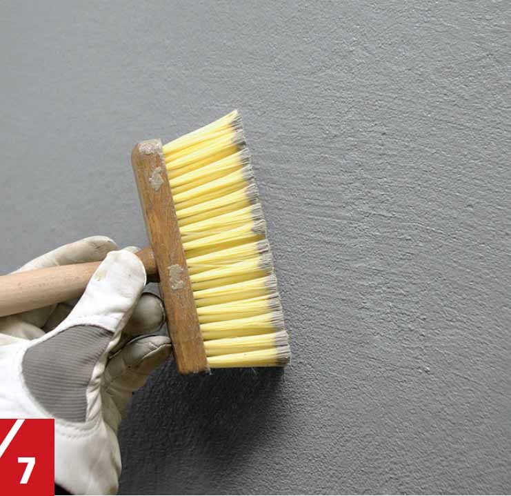 Lasikuitutapetin päällä olevaa laastipintaa sivellään märällä kalkkiharjalla