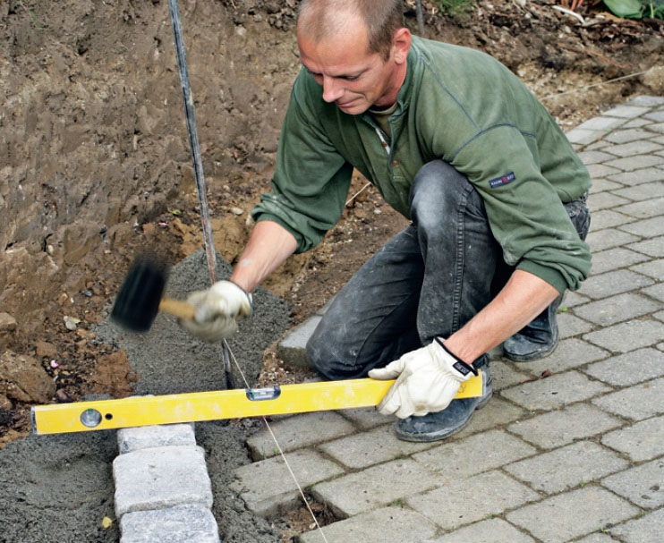 Bygga stenmur: Första raden stenar läggs på plats