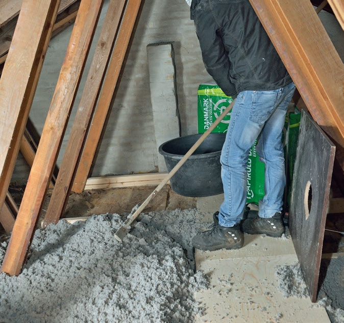 En asfaltrager bruges til at fordele papiruld på loftet