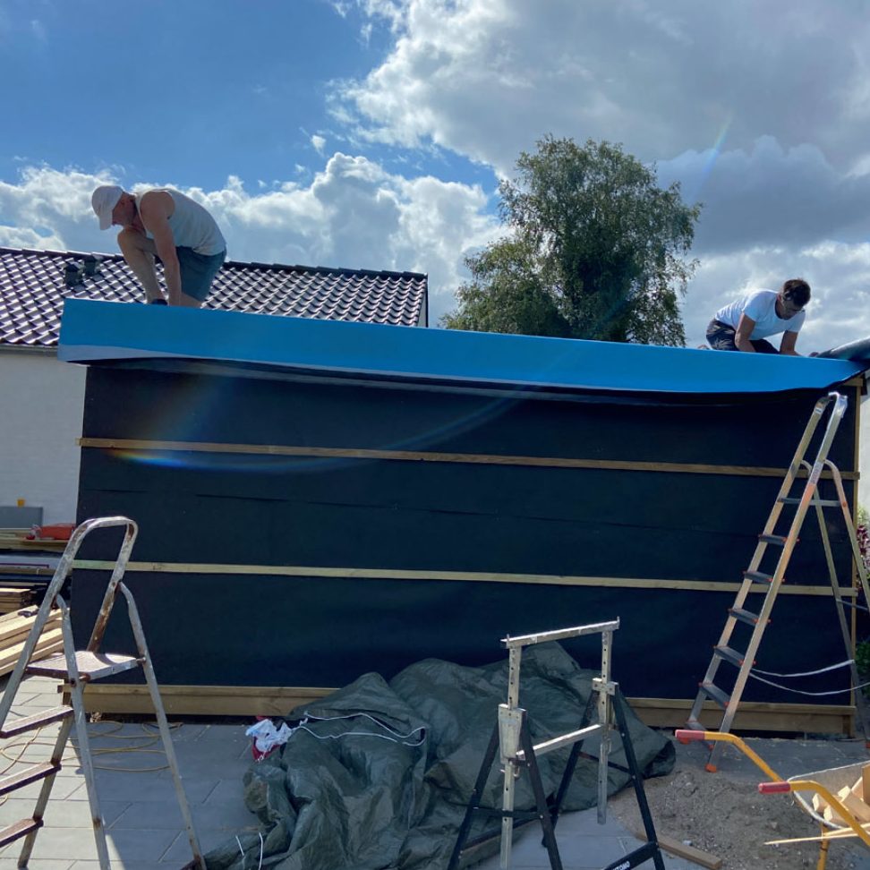 Redskapsbod isolert: Underbelegget rulles ut på hele takflaten