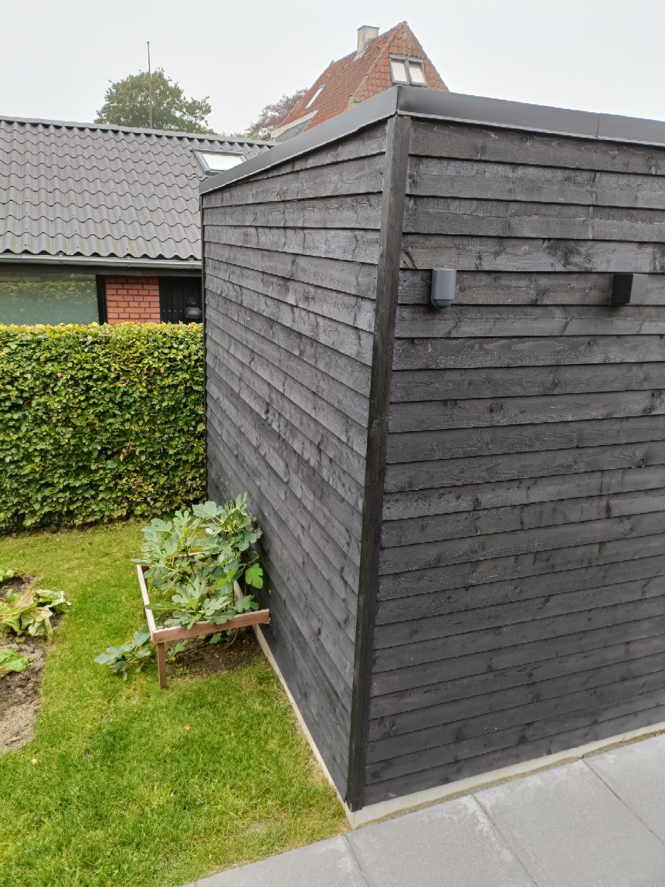 Överbyggd uteplats och förråd