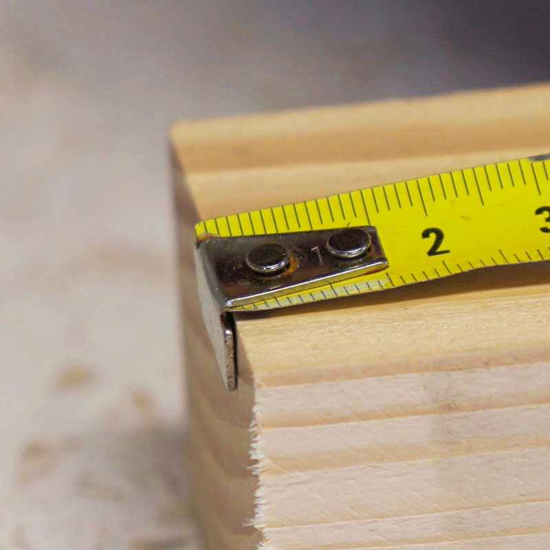 Målebåndets hage giver sig