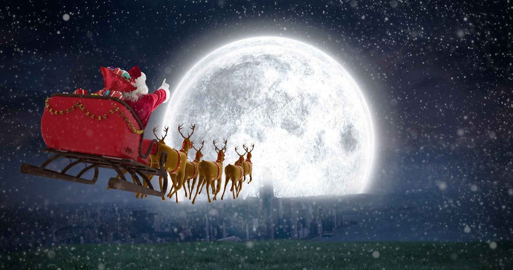 Jultomten i sin släde med renar på julafton Jultomten i sin släde med renar på julafton
