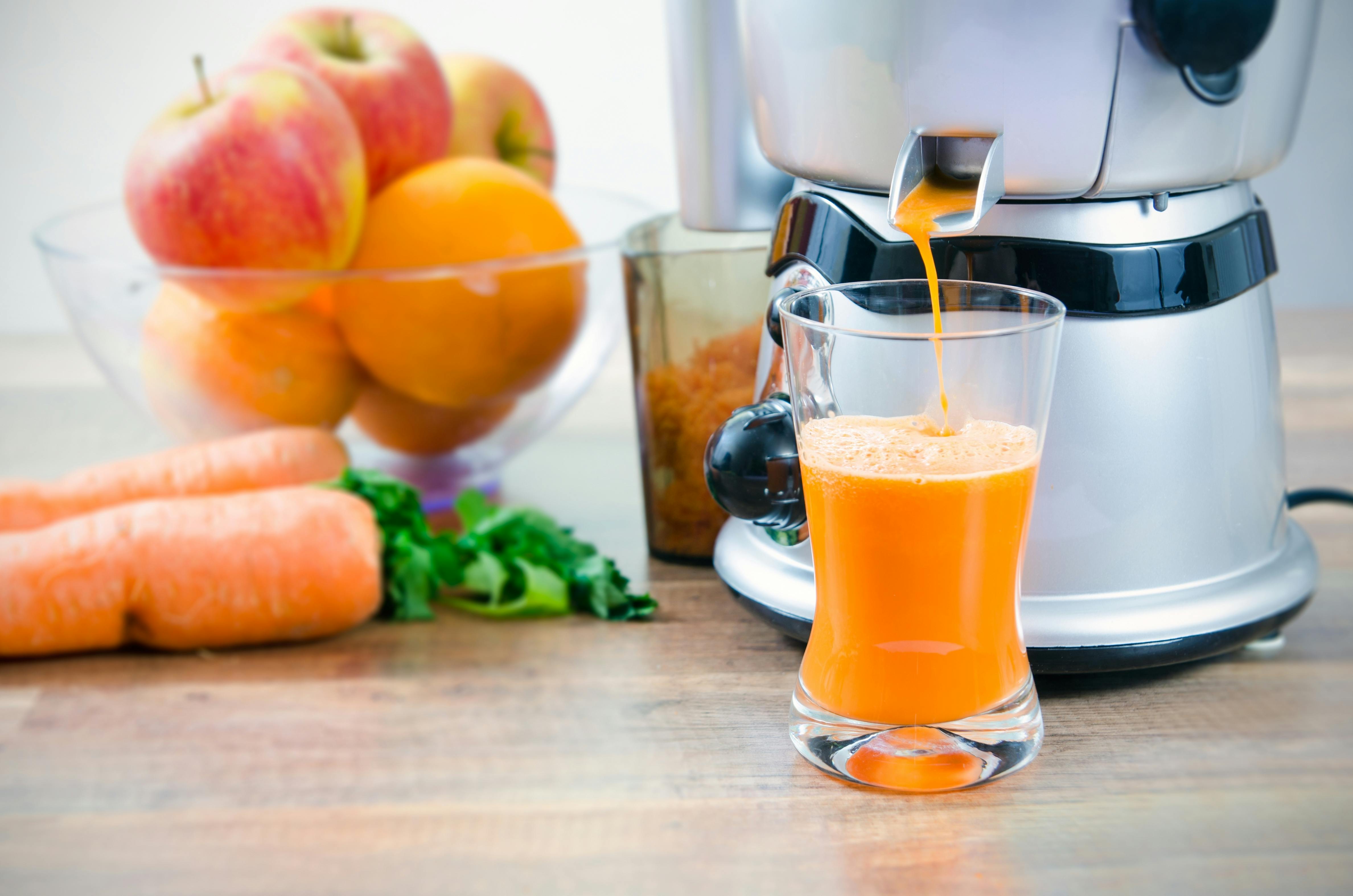 Juicemaskine og frugt på bord