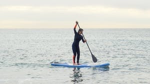 Kvinna på stand up paddle