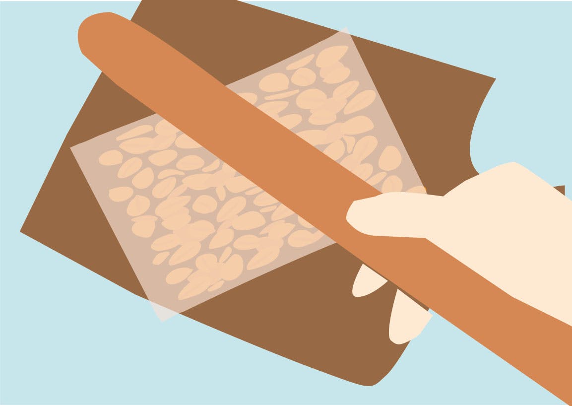 Illustration av en hand som håller en kavel – redo att finmala jordnötter i en påse