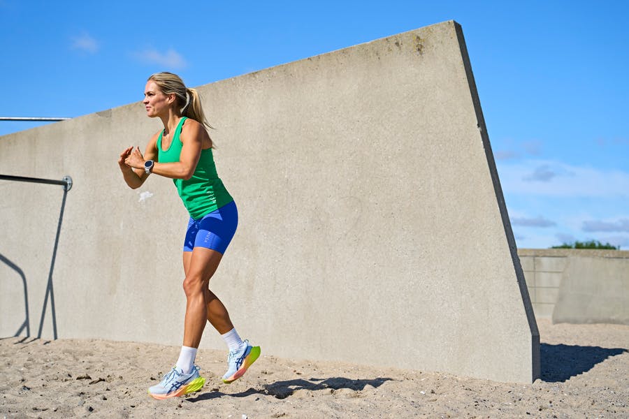 kvinde viser HIIT-øvelse jump lunge