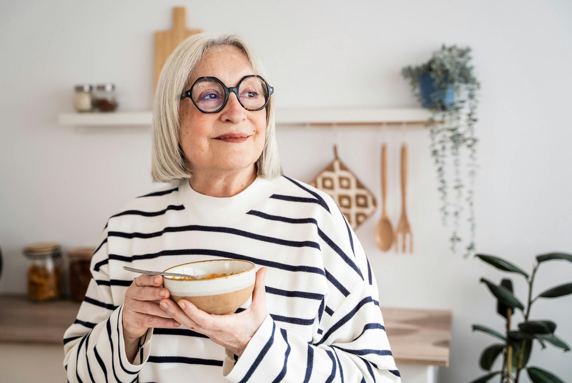 Moden kvinde med morgenmadsskål