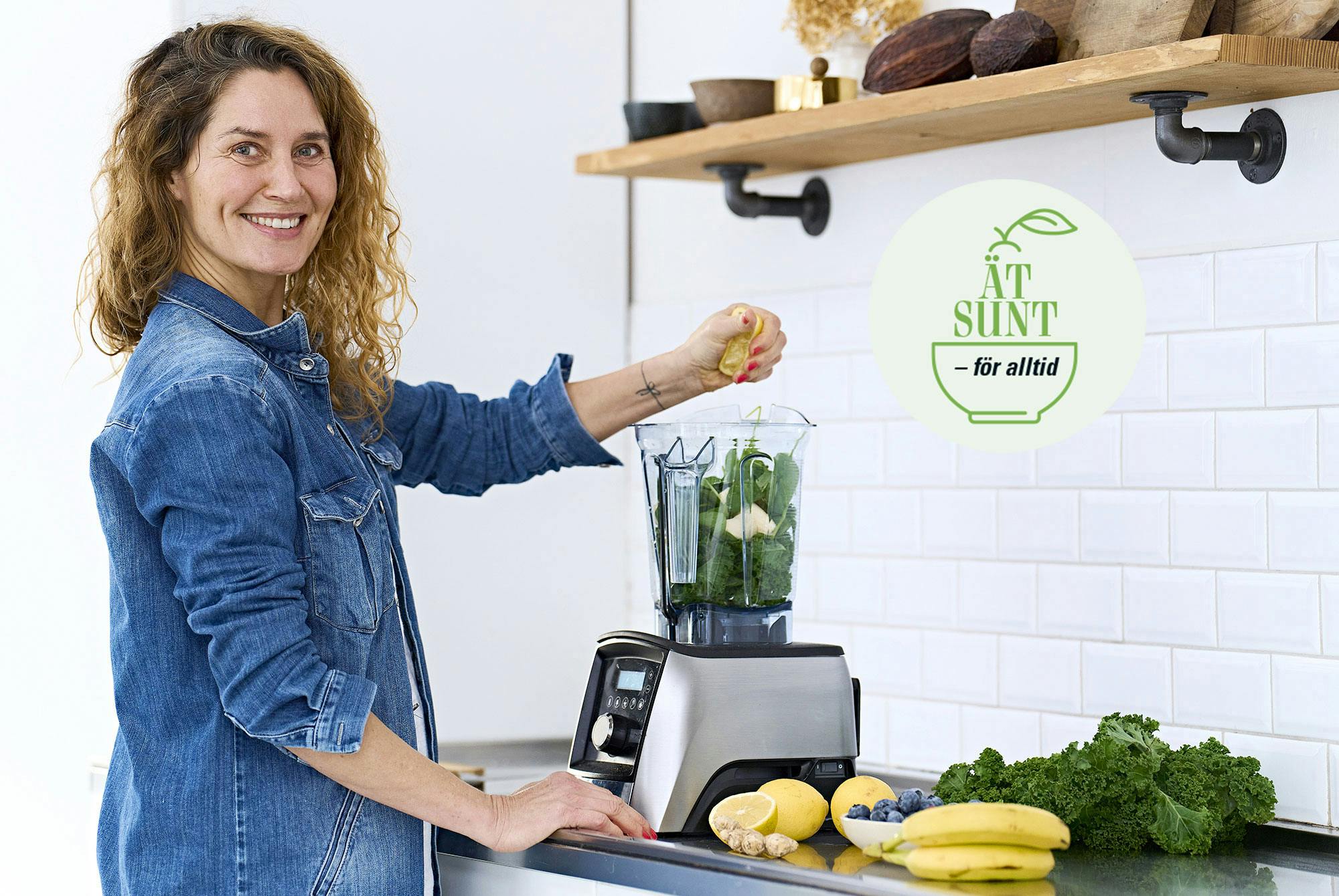 Kvinna lägger frukt och grönsaker i en mixer