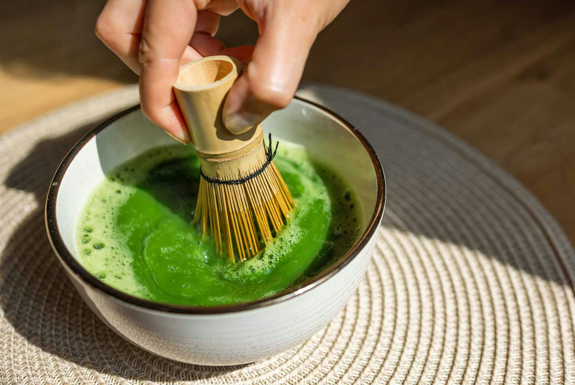 Matcha-teetä sekoitetaan vispilällä.