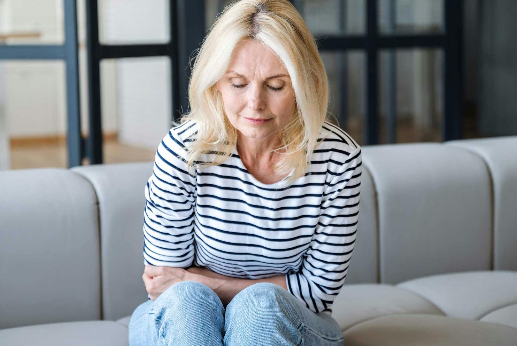 Vaihdevuosi-ikäisellä naisella on ilmavaivoja ja kipua