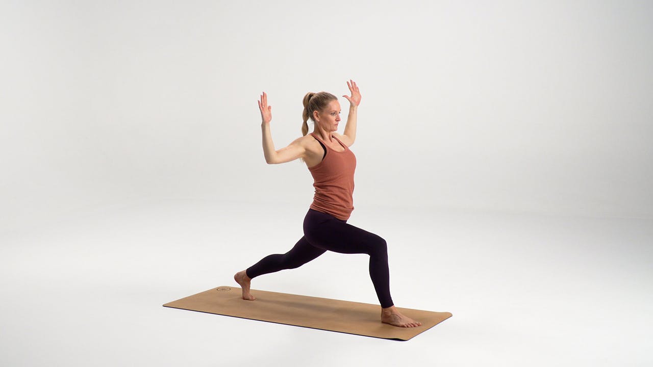 Kvinde laver høj lunge med kaktusarme