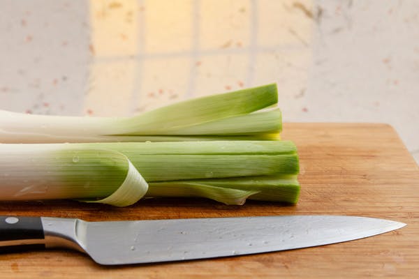 Den grønne del af porren, hvor der er skåret nogle snit med en kniv