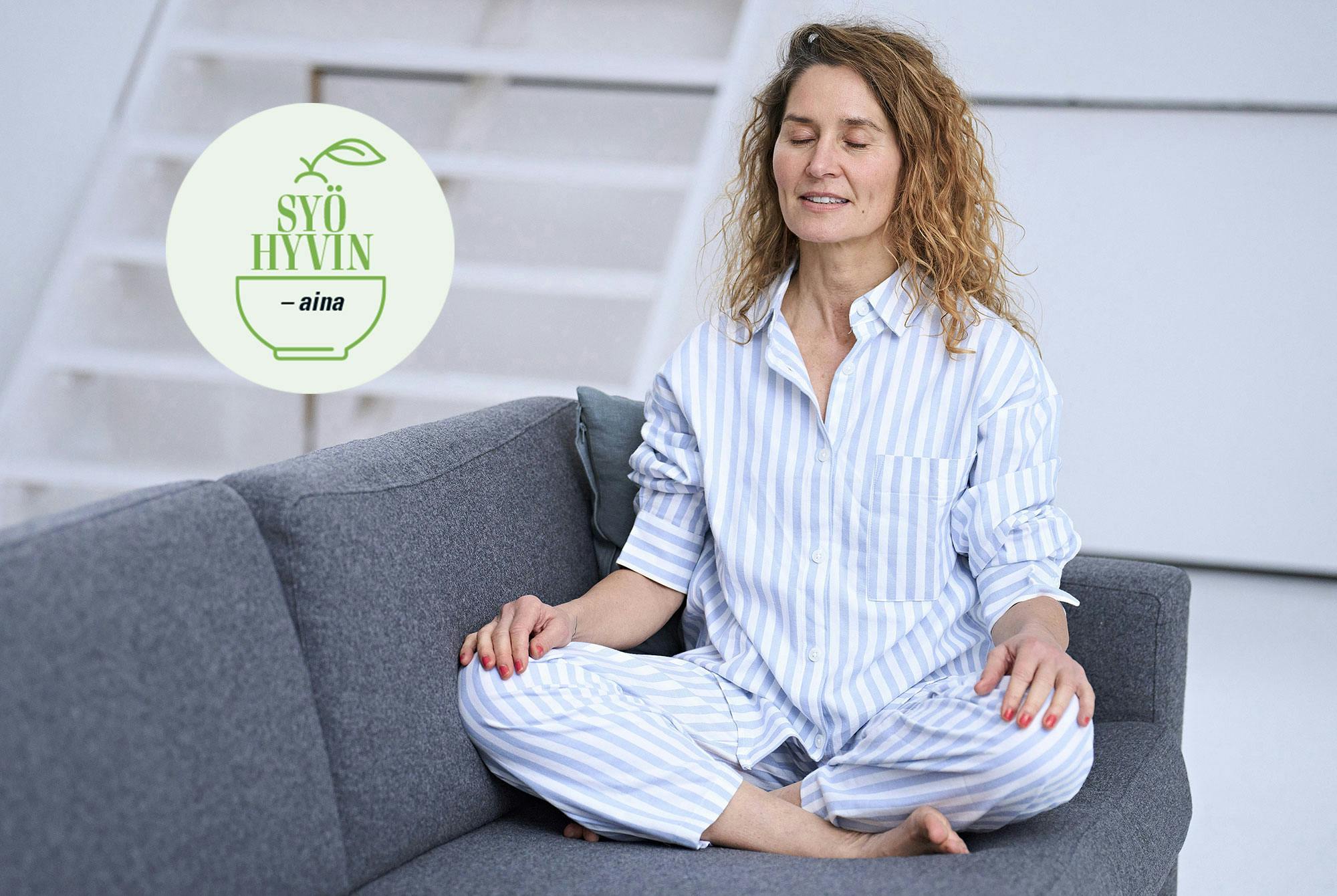 Nainen pyjamassa joogaa sohvalla