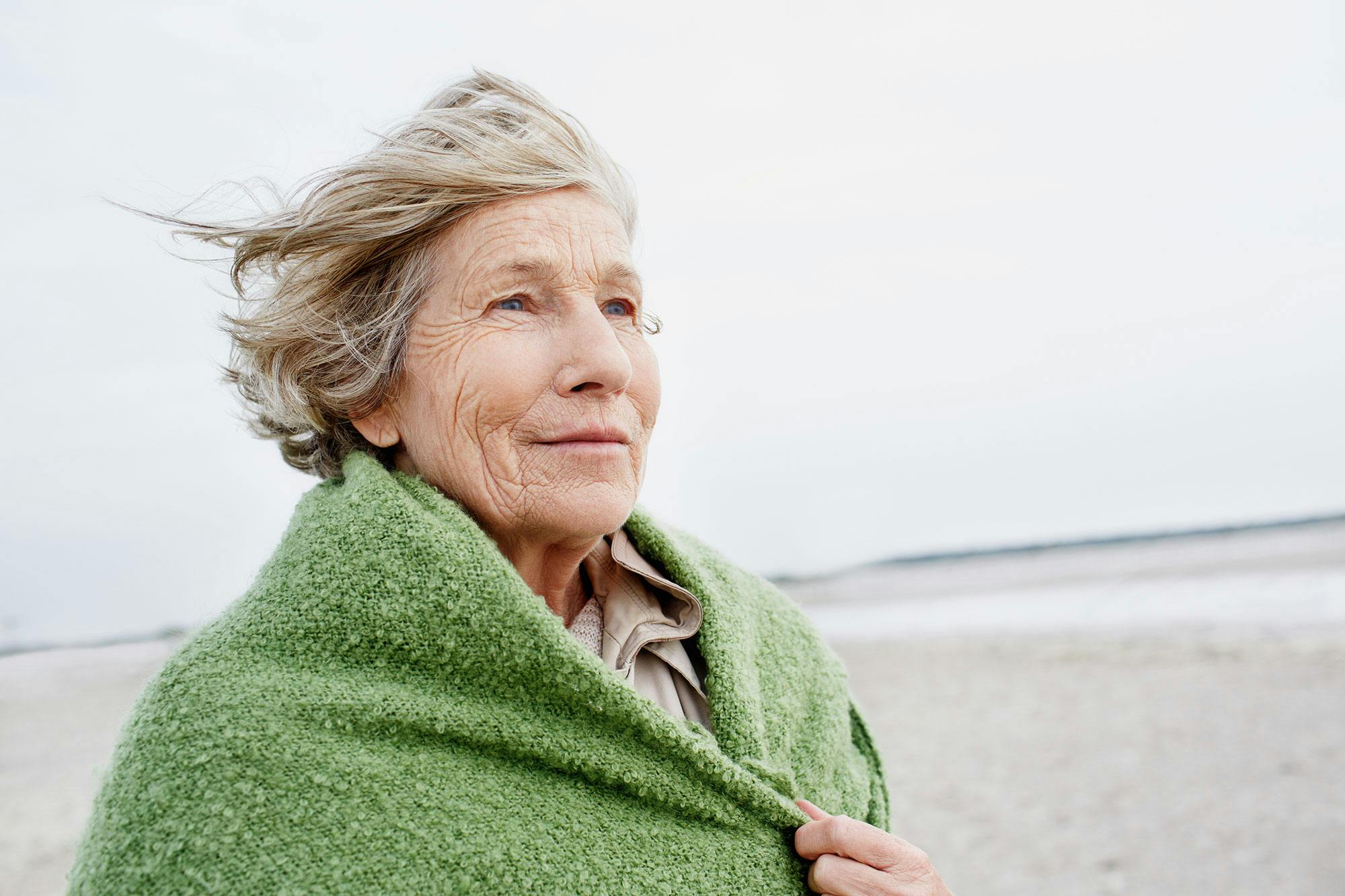 En eldre kvinne går på en strand og tenker på livet og tidens hastighet.