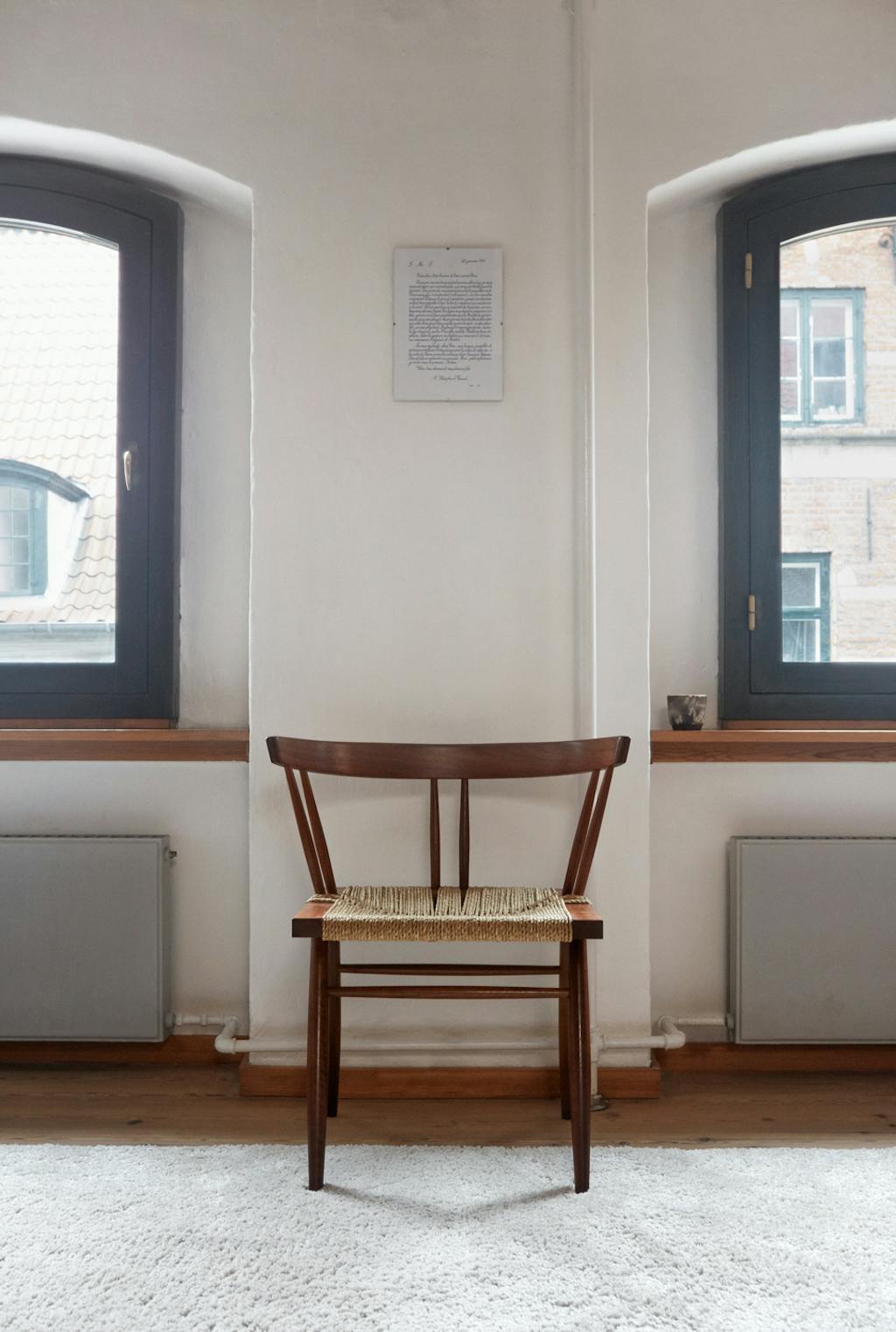 wooden George Nakashima chair with rug