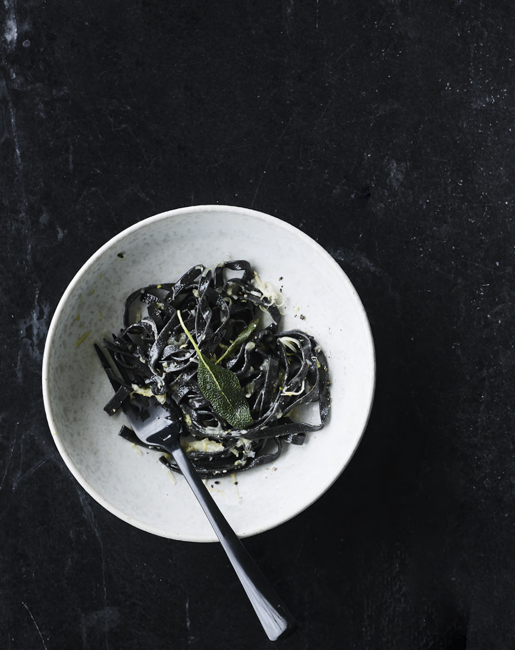 Havgus – het Deense antwoord op Parmezaanse kaas. De kommen en borden zijn van keramist Aage Würtz. Zwart bestek van Table Noir en Gense. zwarte pasta havguskaas havgus